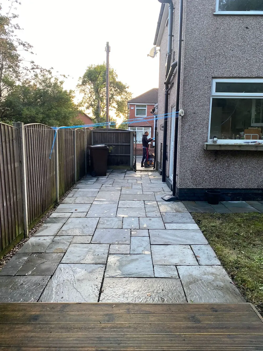 A clean new grey sandstone path Emad laid alongside a Greater Manchester home, finished to a tidy standard